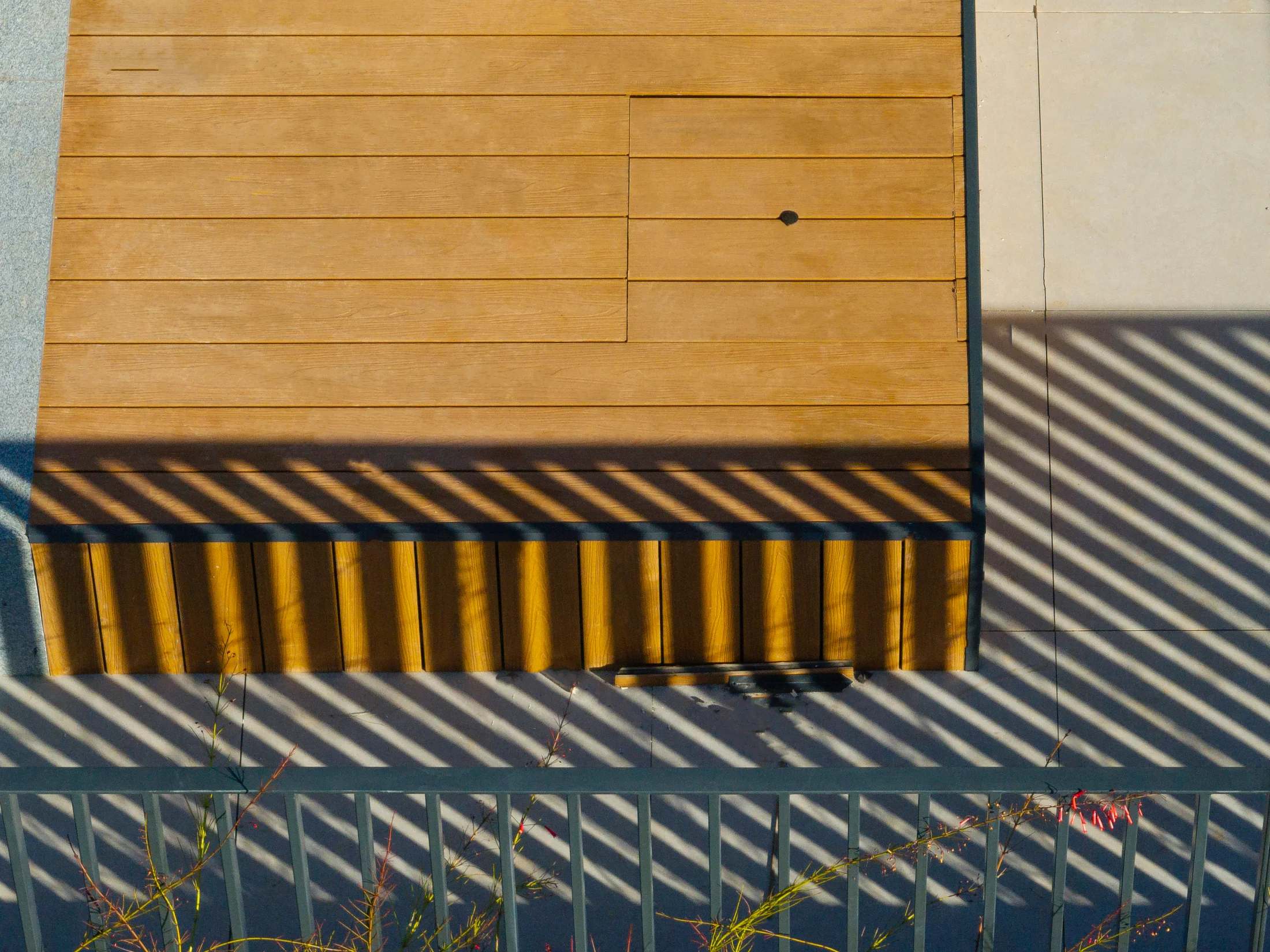 Lesco ecological wood decking seen from above, with the railing casting its shadow.